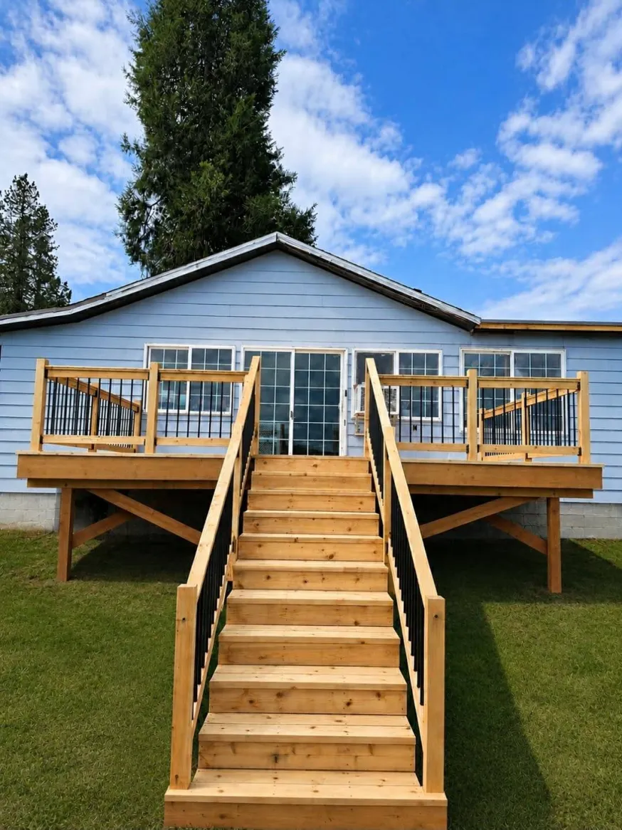 Light blue home with new cedar deck and wide center staircase