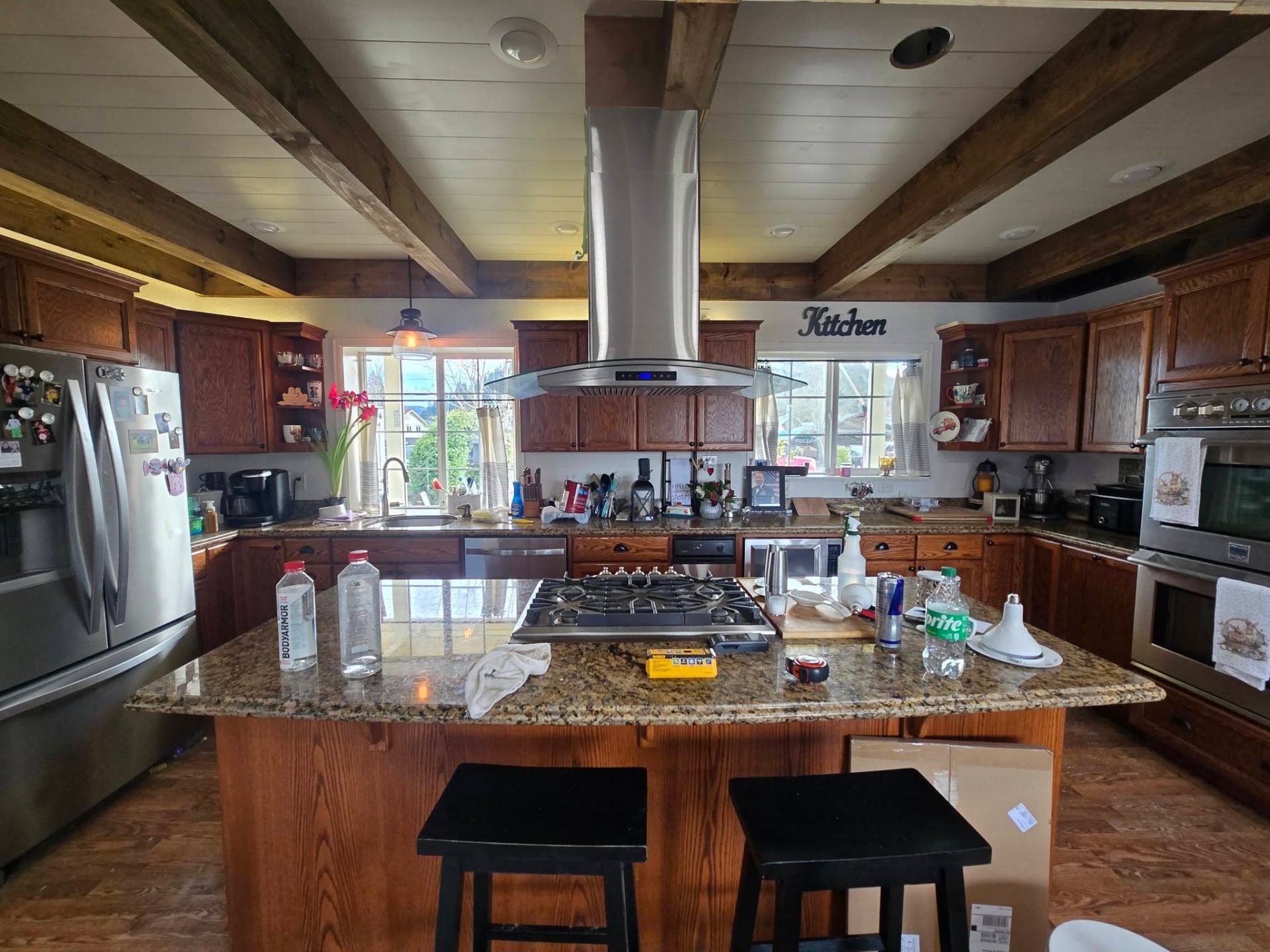 Kitchen with refinished natural wood ceiling beams and updated lighting