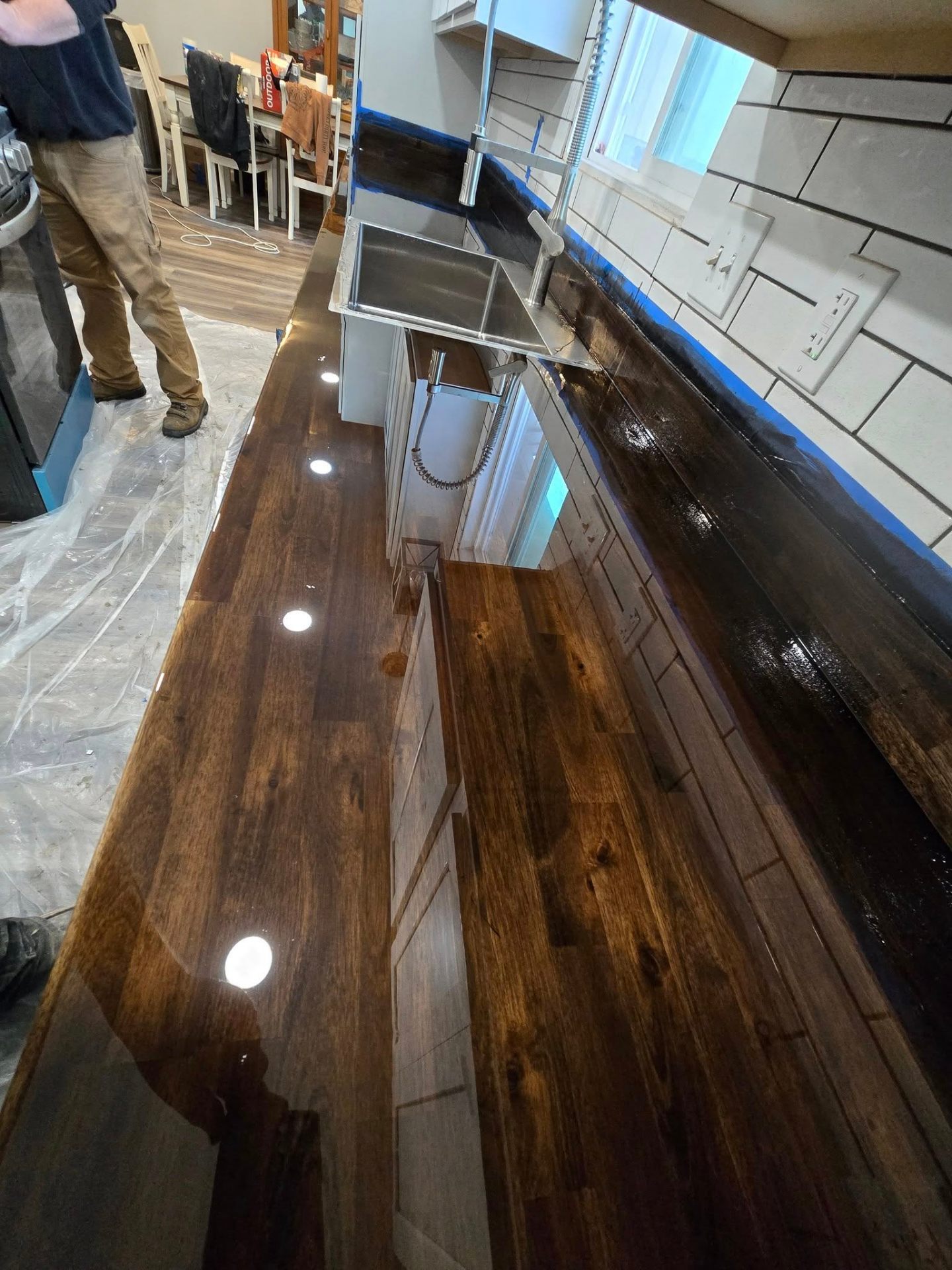Glossy epoxy-finished butcher block countertop in a remodeled kitchen